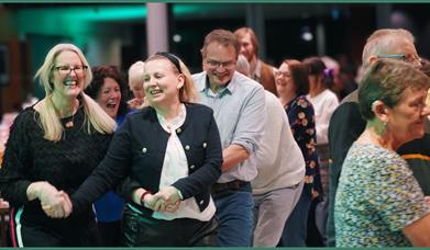 Dancers enjoying an energetic ceilidh together